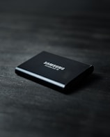 black power bank on black wooden table