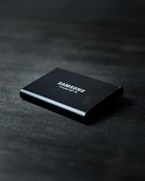 black power bank on black wooden table