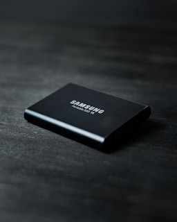 black power bank on black wooden table