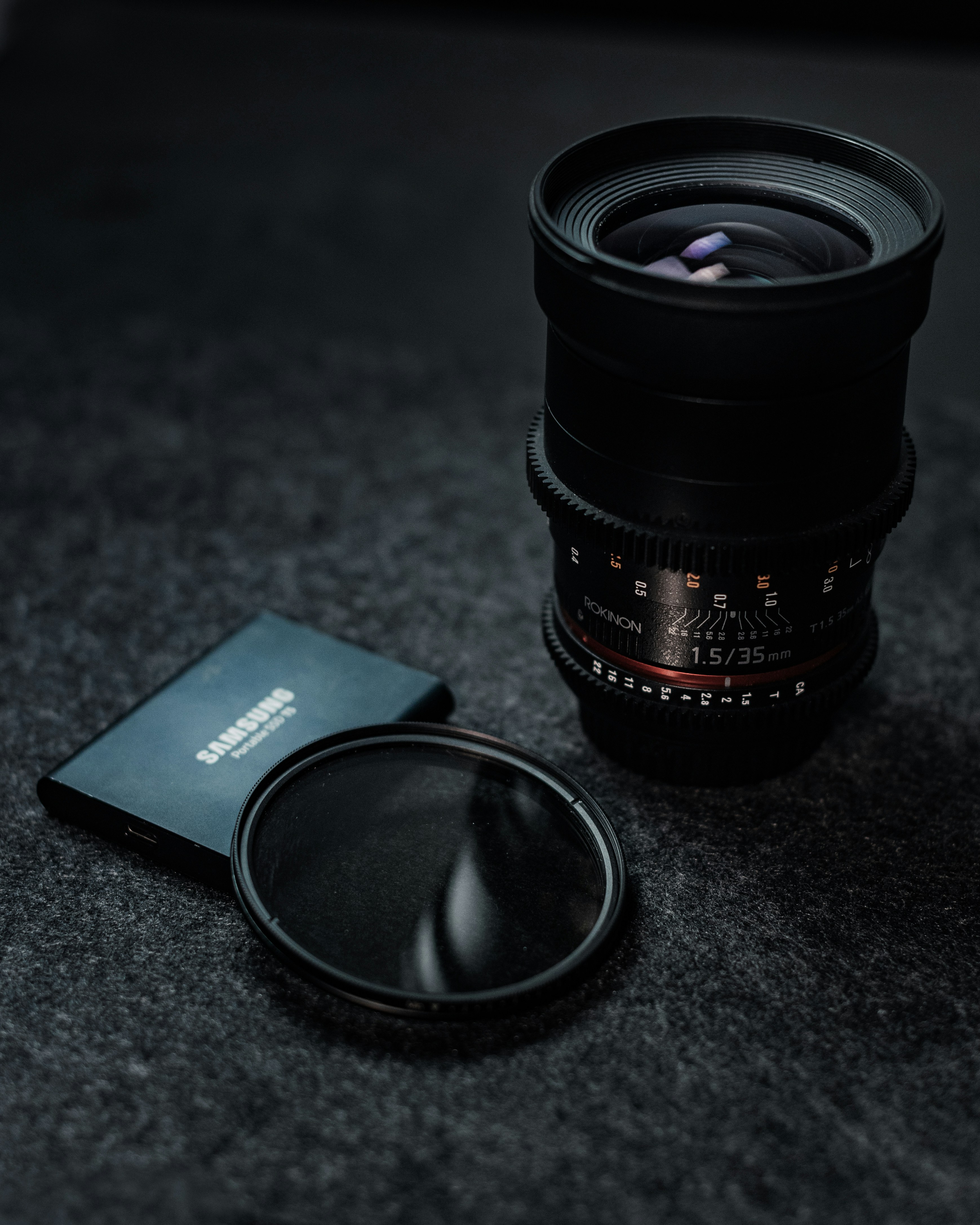 black camera lens beside black samsung galaxys 7 edge