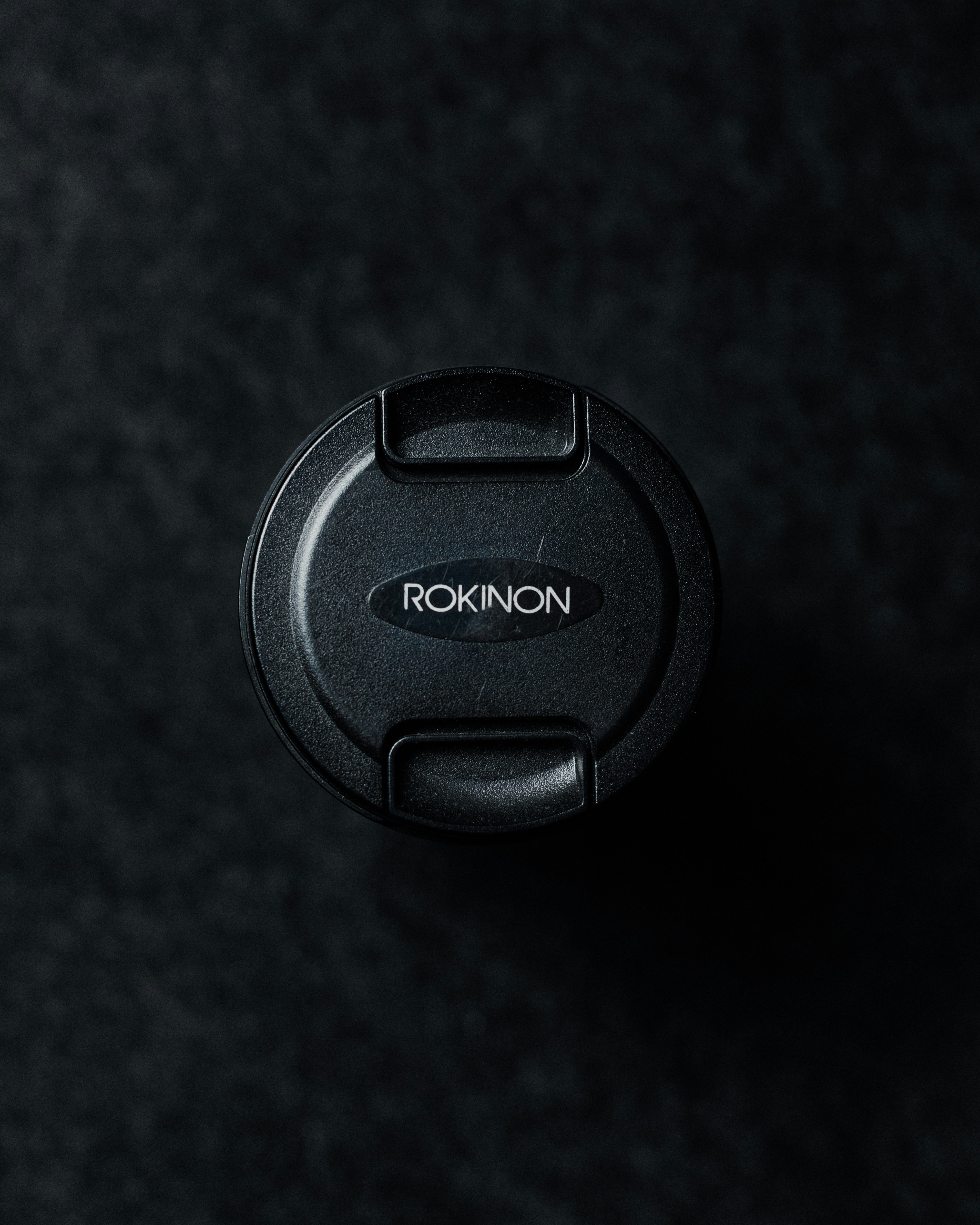 black nikon camera lens cover