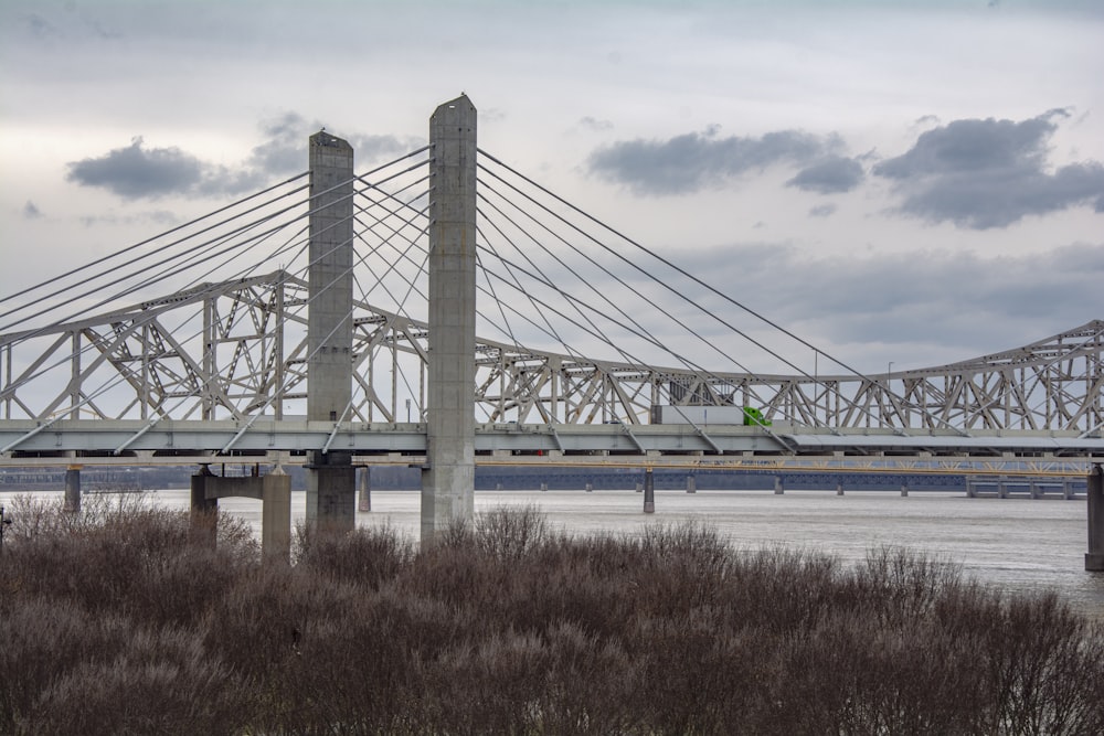 gray bridge under white clouds during daytime