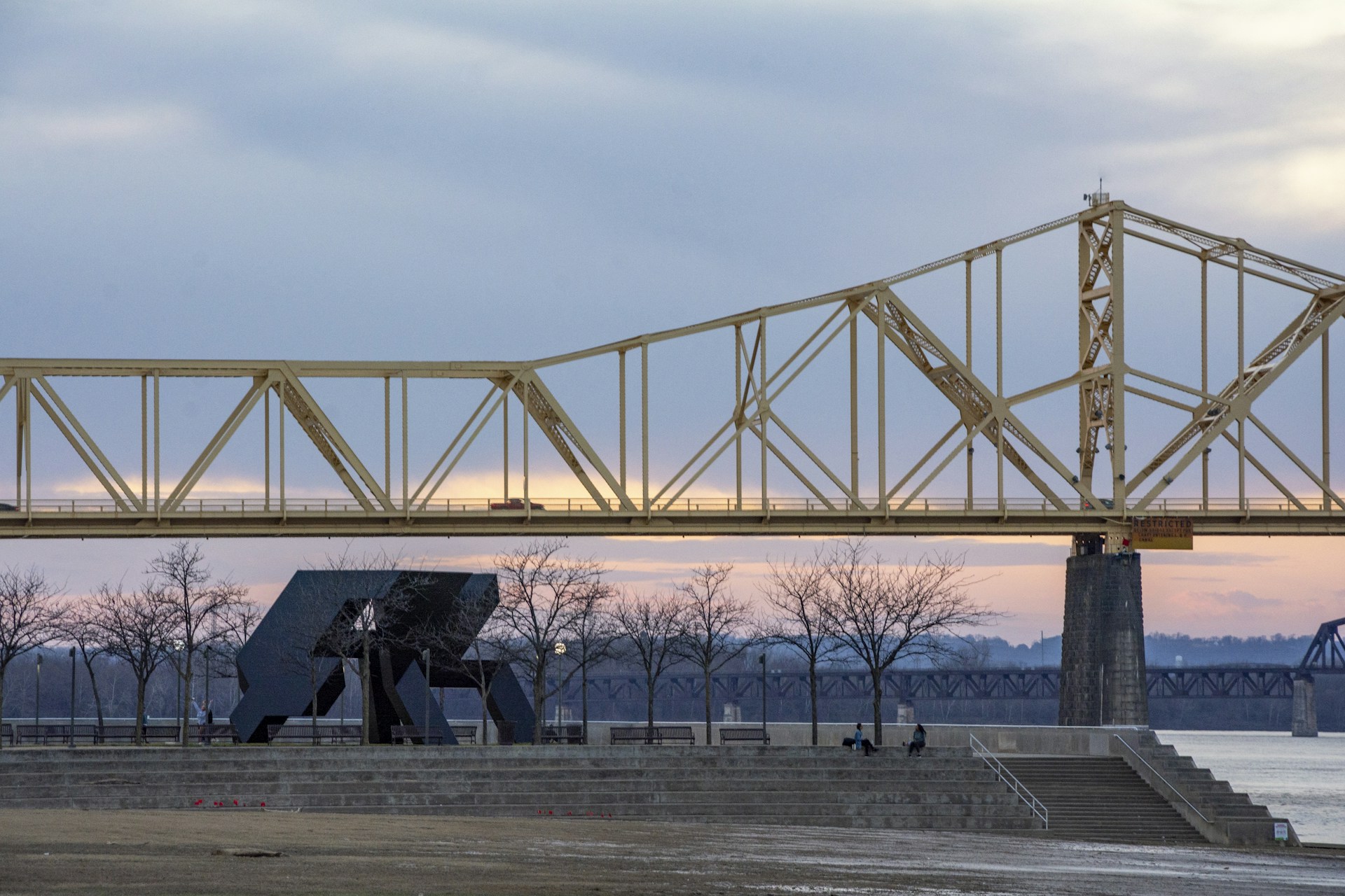 silhouette of person standing on concrete floor during sunset