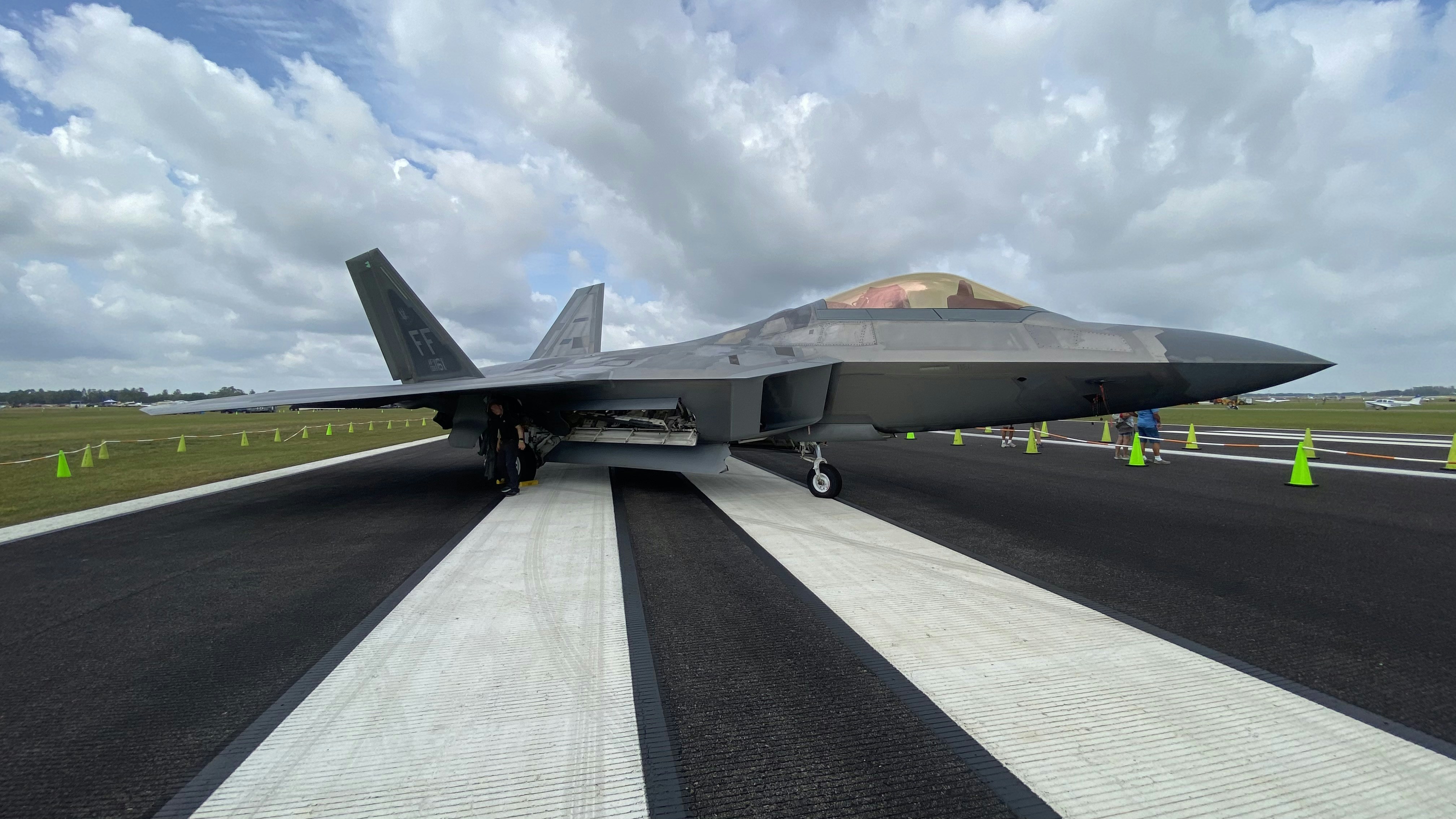 black fighter jet on gray concrete pavement during daytime, F22 Raptor at Sun ‘N Fun 2021
