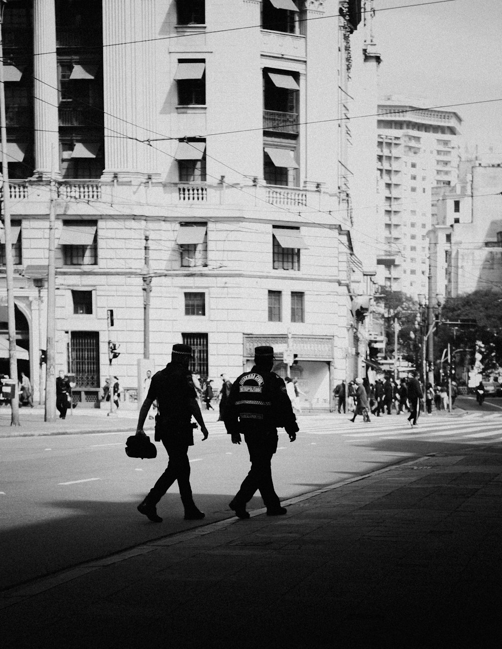 grayscale photo of man walking on street