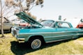 green vintage car on green grass field during daytime