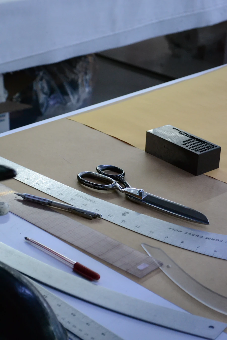 Silver dressmaking scissors beside a black box