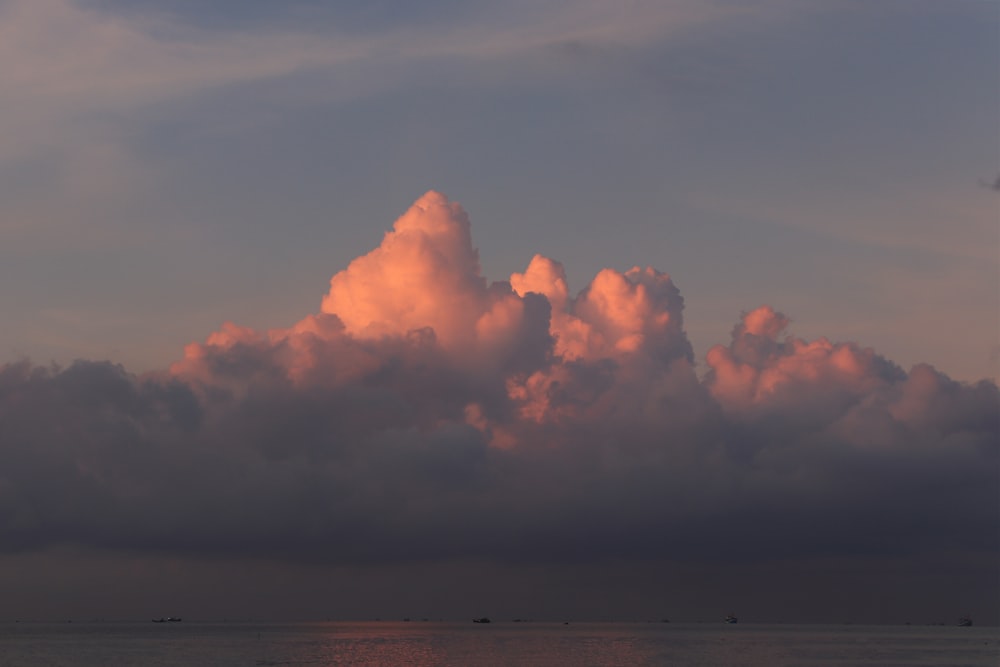 white clouds over the sea during sunset