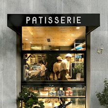 man in white dress shirt and black pants standing in front of store