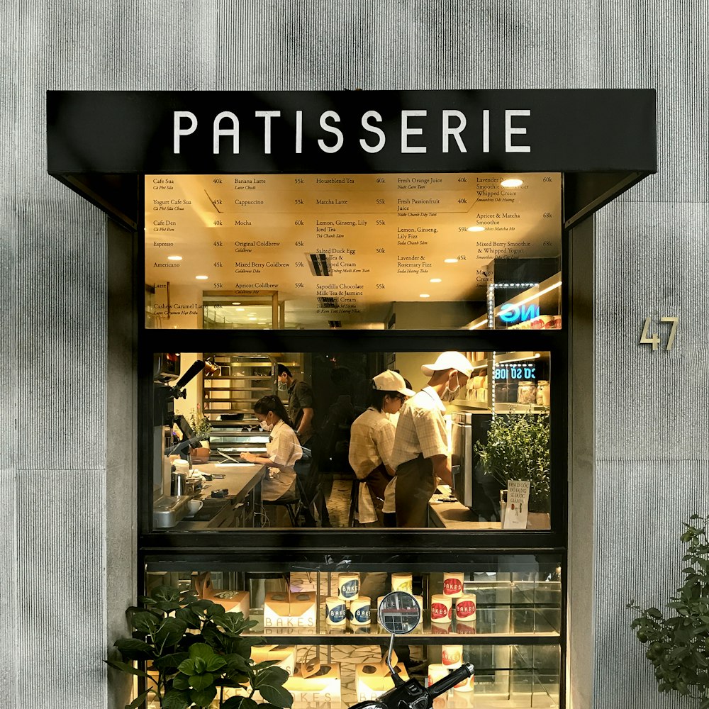 man in white dress shirt and black pants standing in front of store