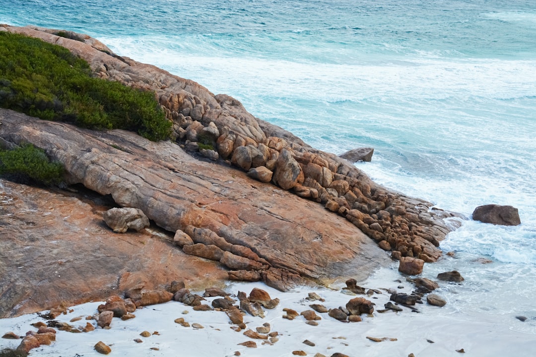 brown rock formation on beach during daytime