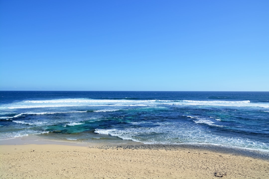 sea waves crashing on shore during daytime