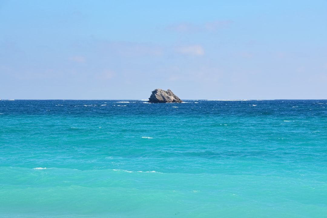 brown rock formation on sea during daytime