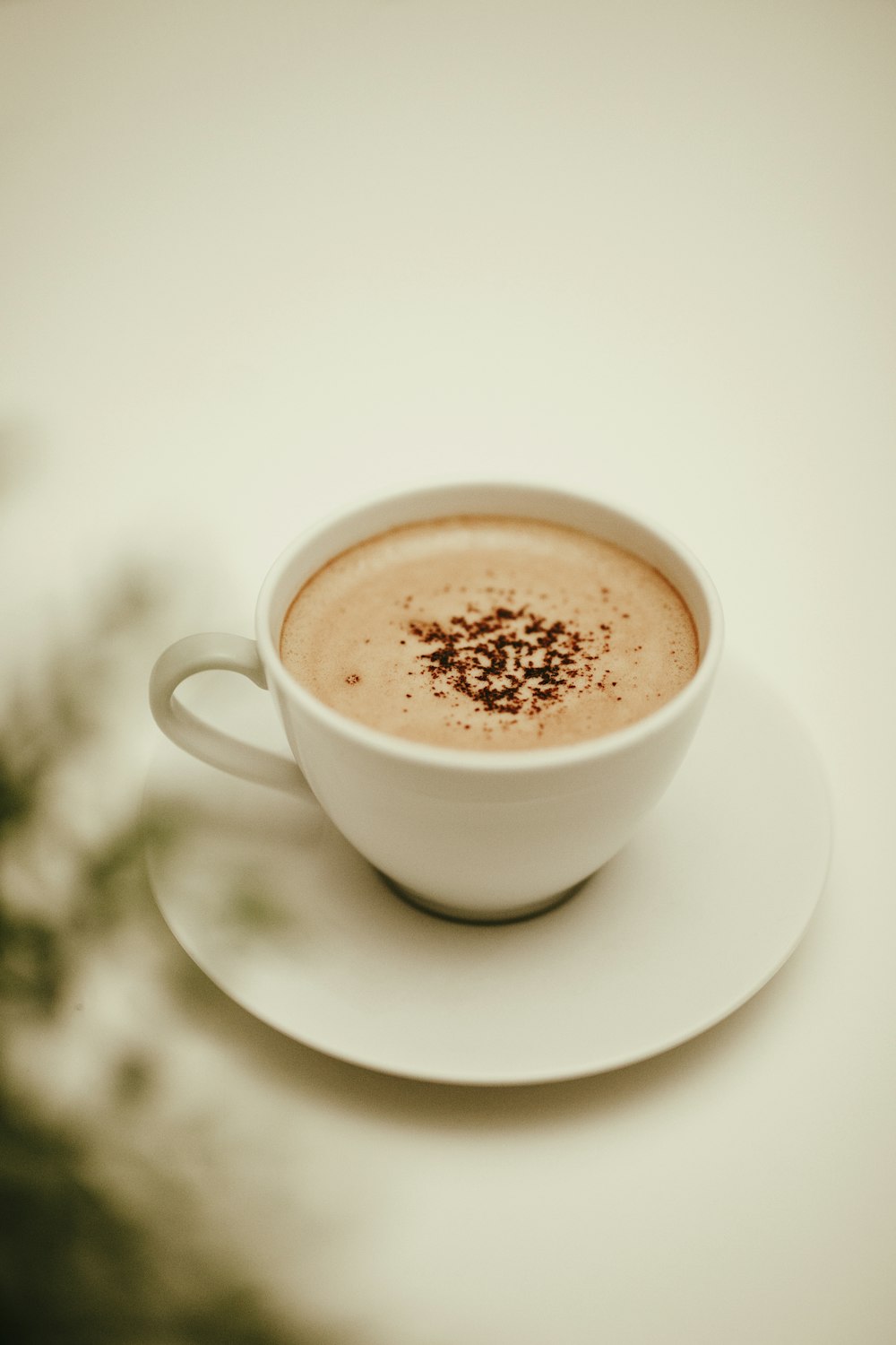 white ceramic cup with brown liquid