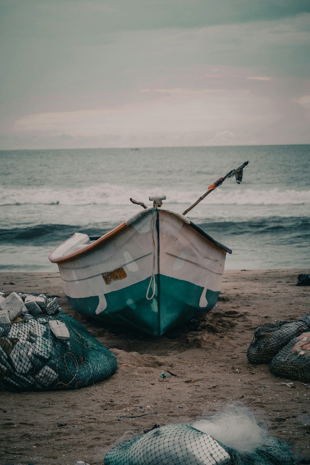 green and white boat on shore during daytime