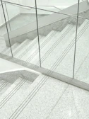 Custom cut-to-size travertine stair system showcasing industrial craftsmanship.