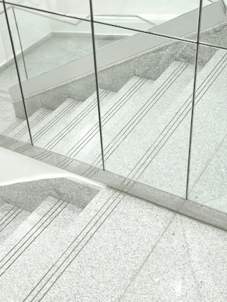 Custom cut-to-size travertine stair system showcasing industrial craftsmanship.