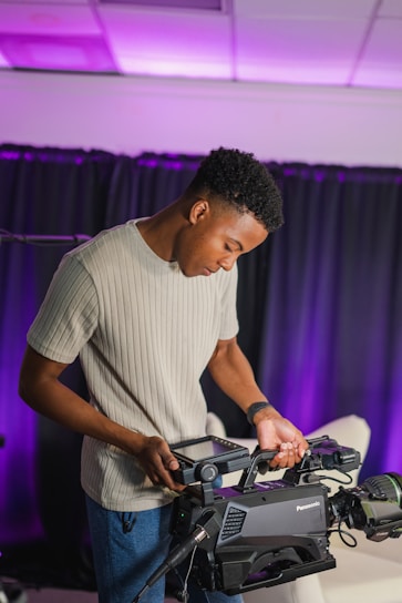 man in white crew neck t-shirt playing dj controller