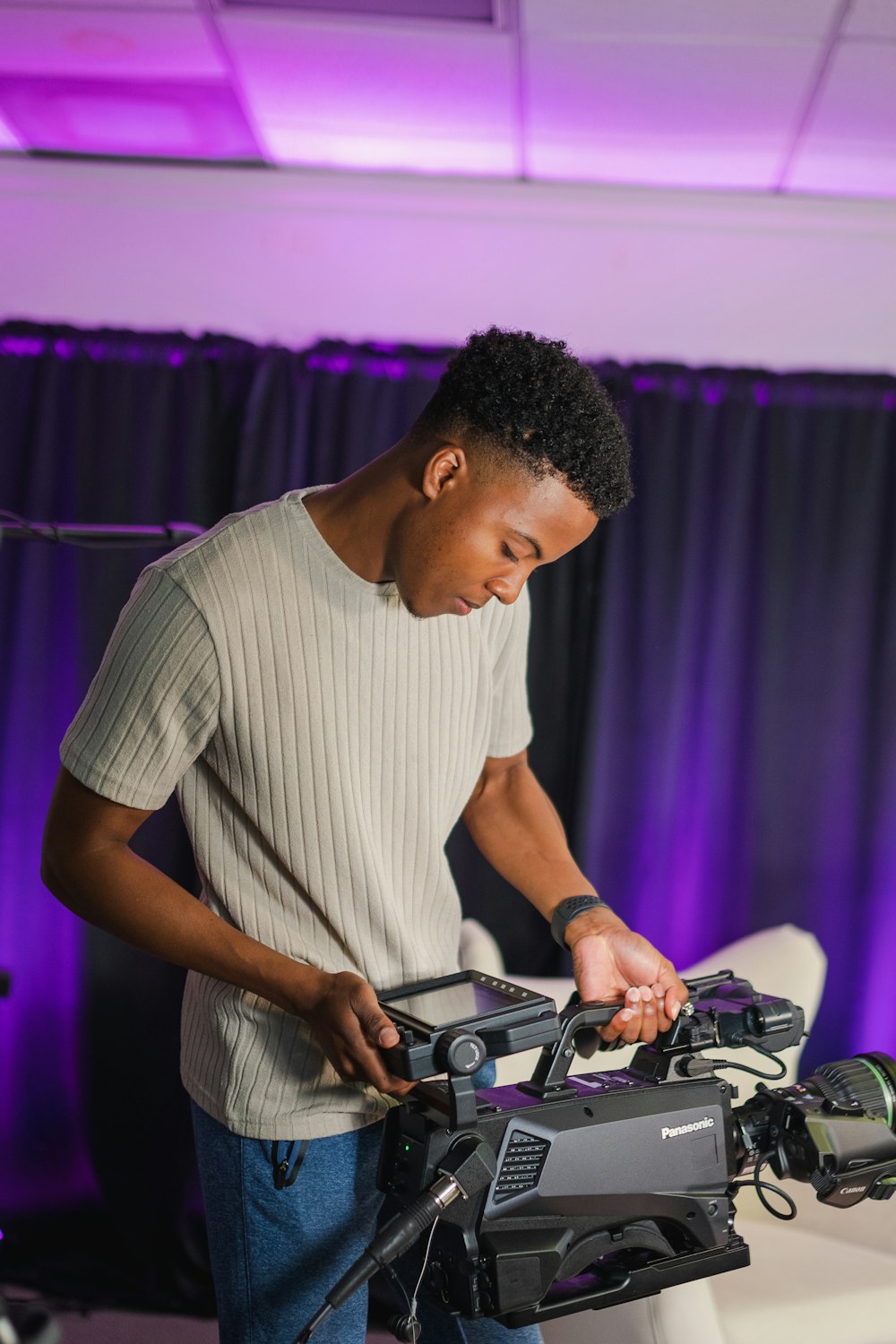 man in white crew neck t-shirt playing dj controller