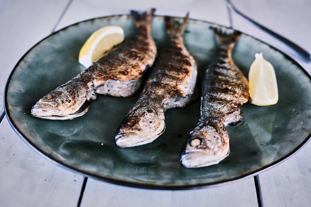 grilled fish on black round plate