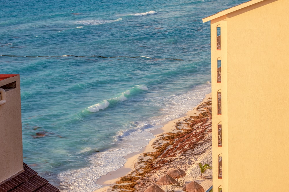 blue sea waves on brown sand beach during daytime