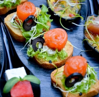 tomato and green leaf vegetable salad on brown wooden plate