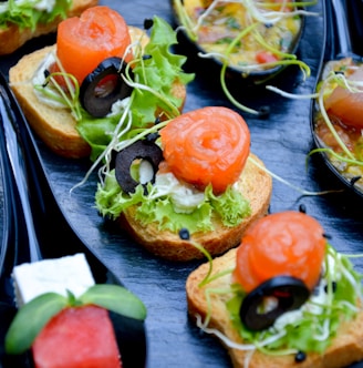 tomato and green leaf vegetable salad on brown wooden plate