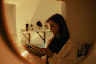 woman in white sweater using tablet computer
