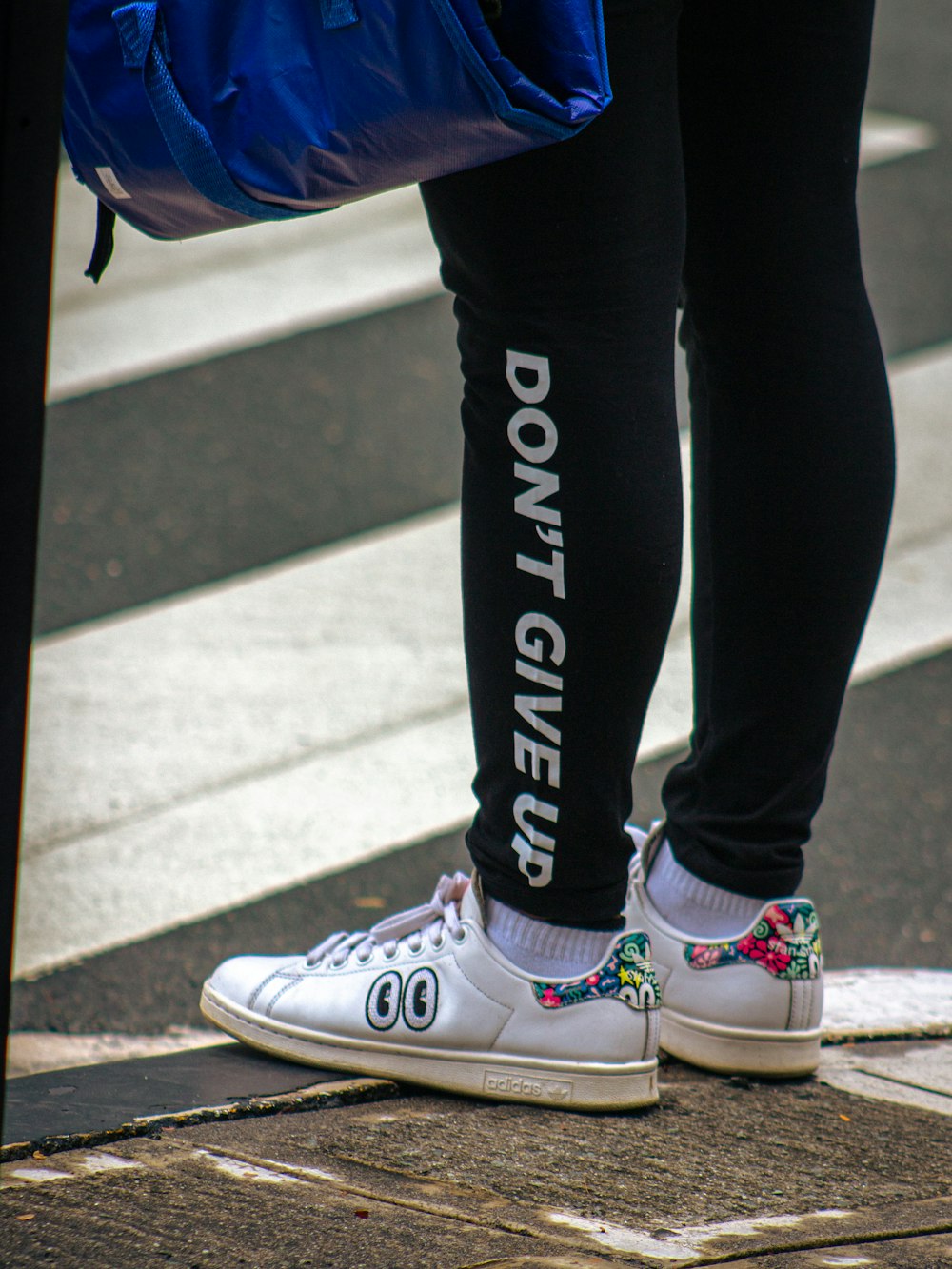 person in black pants and white converse all star high top sneakers