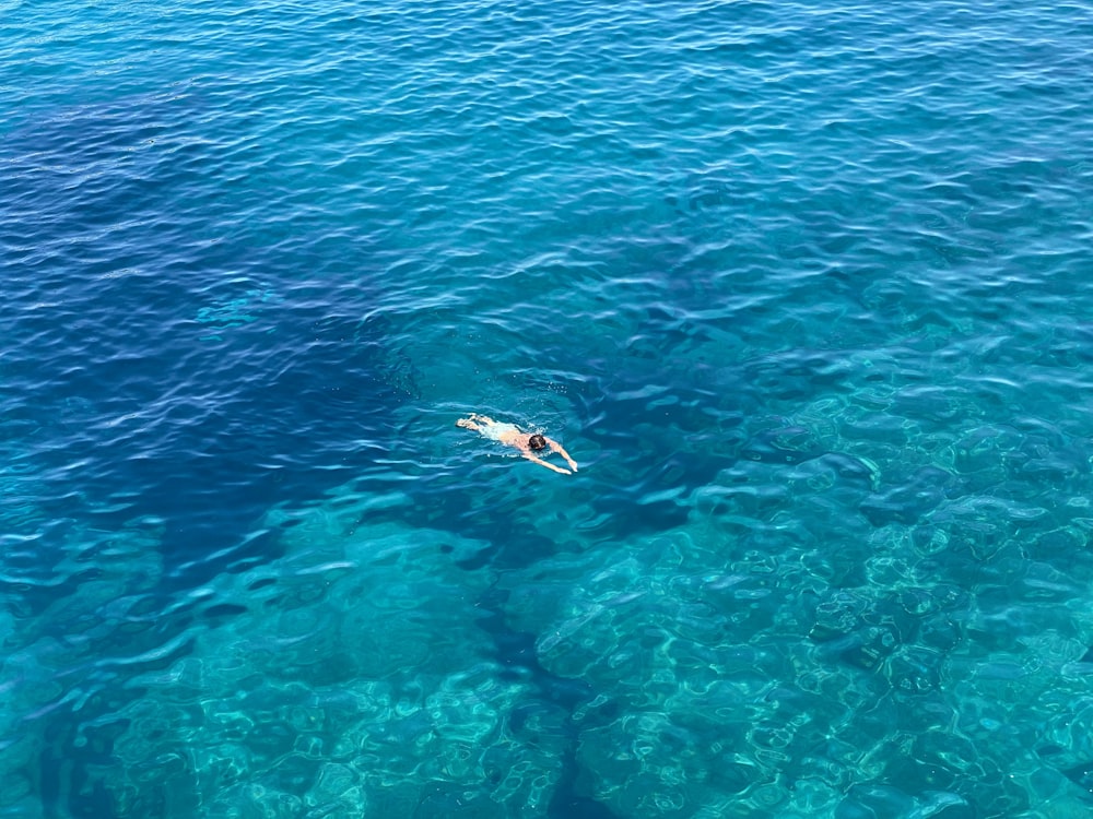 person surfing on blue sea during daytime