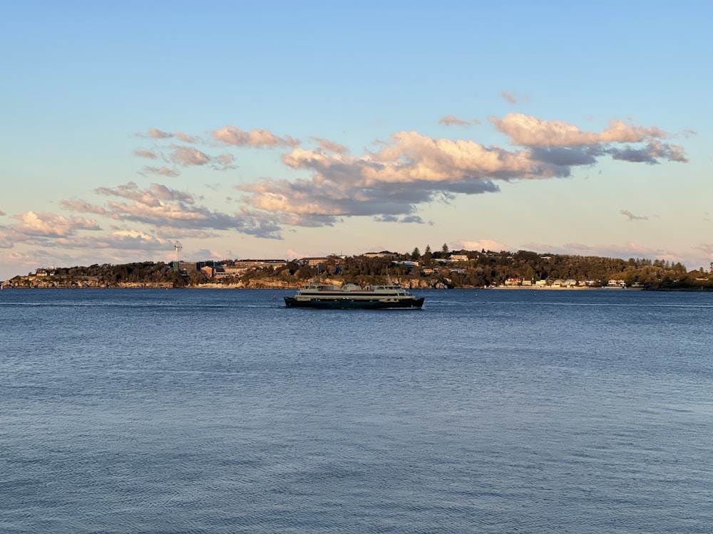 white and black boat on sea under blue sky during daytime