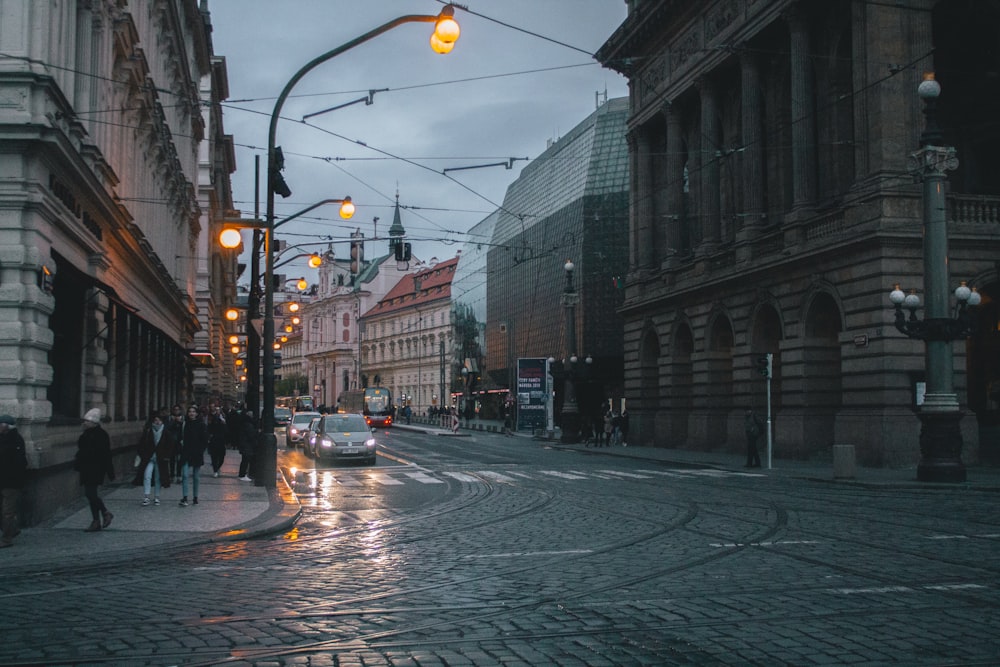 cars on road between buildings during daytime