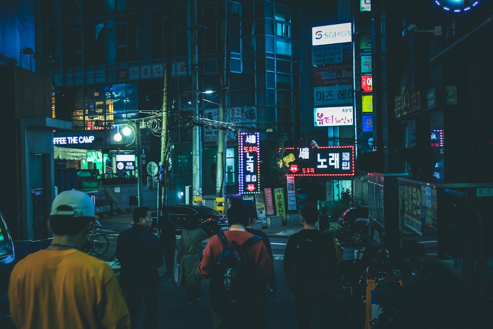 people walking on street during night time