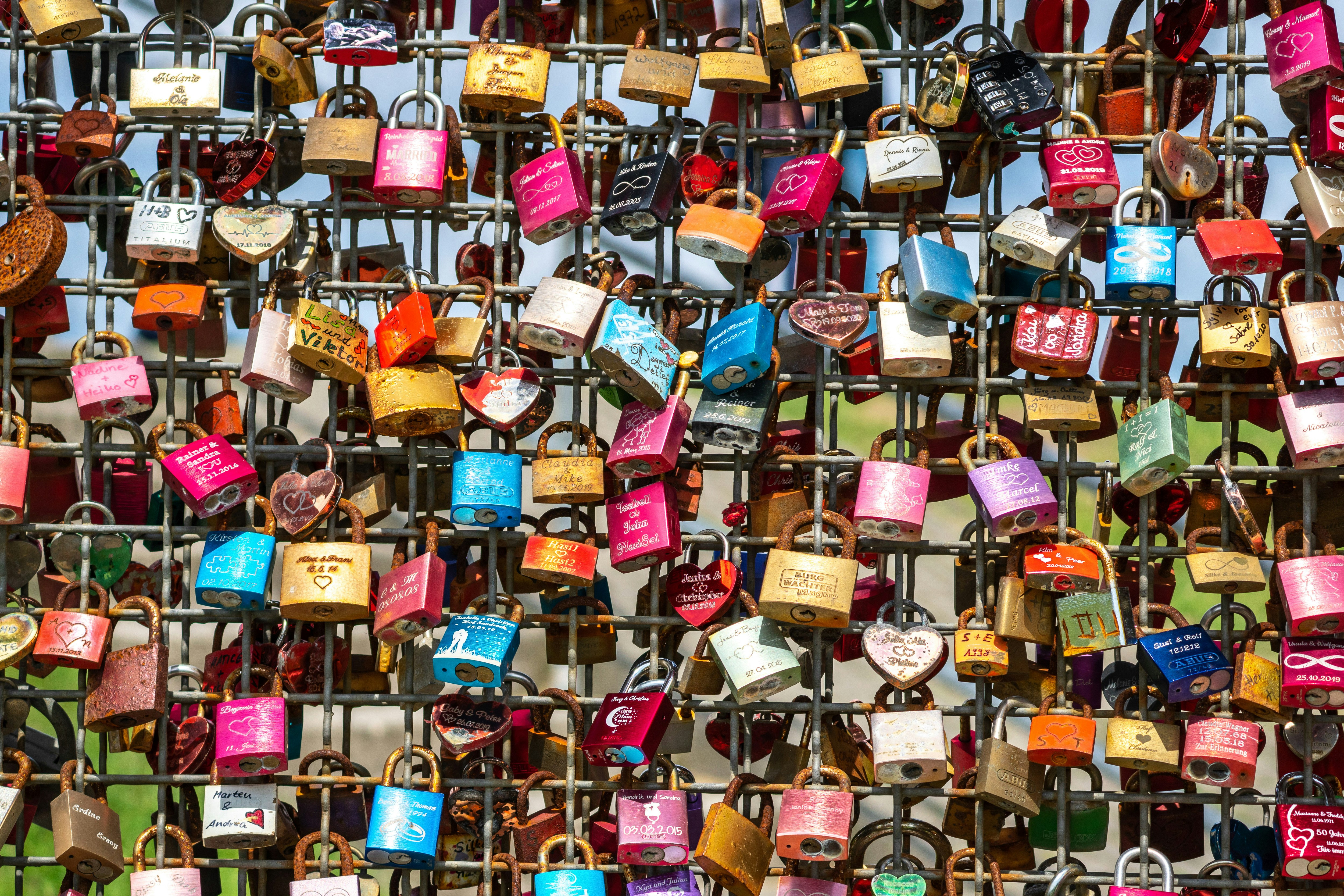 padlocks on brown wooden fence during daytime