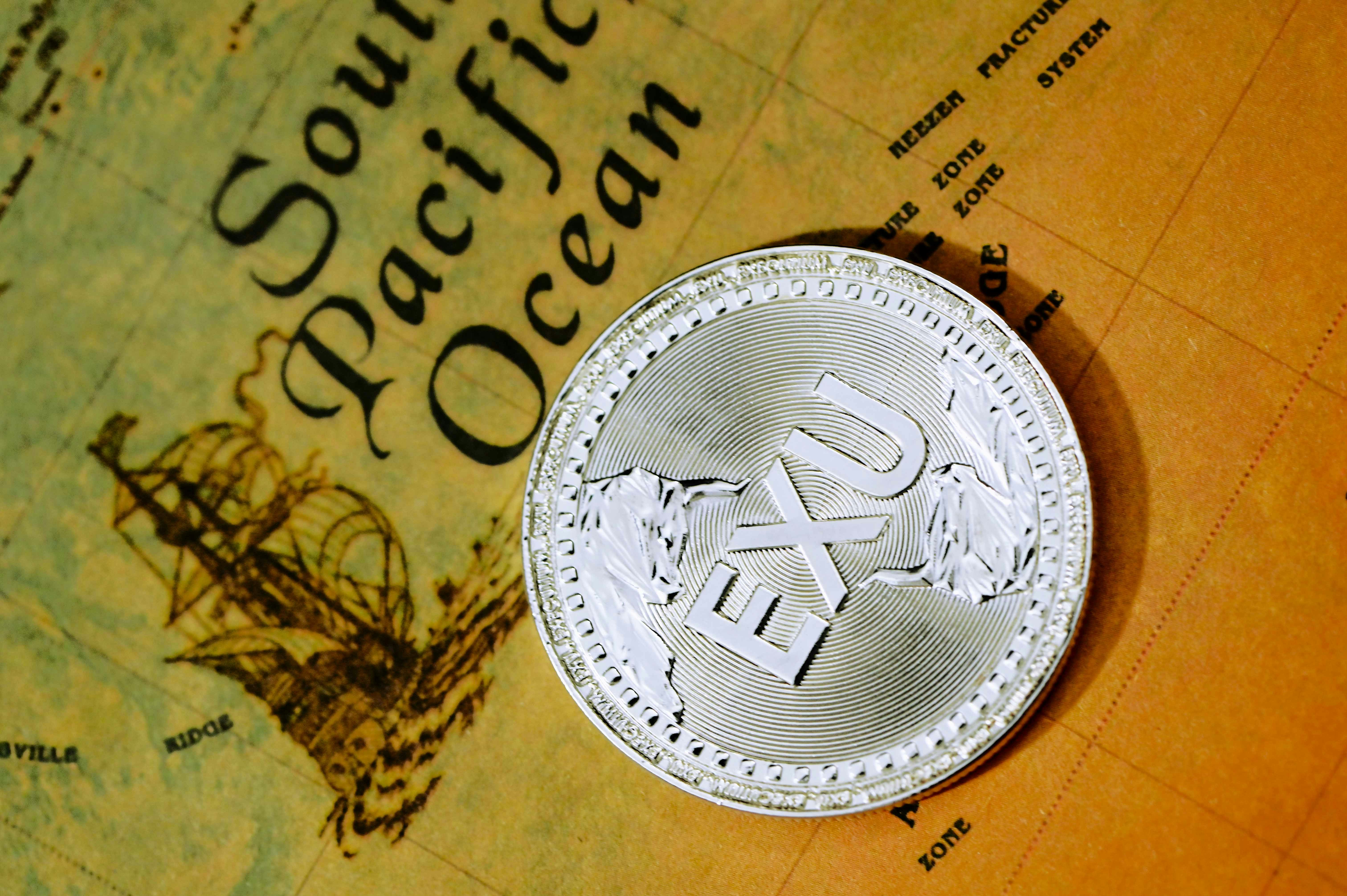 silver and gold round coin