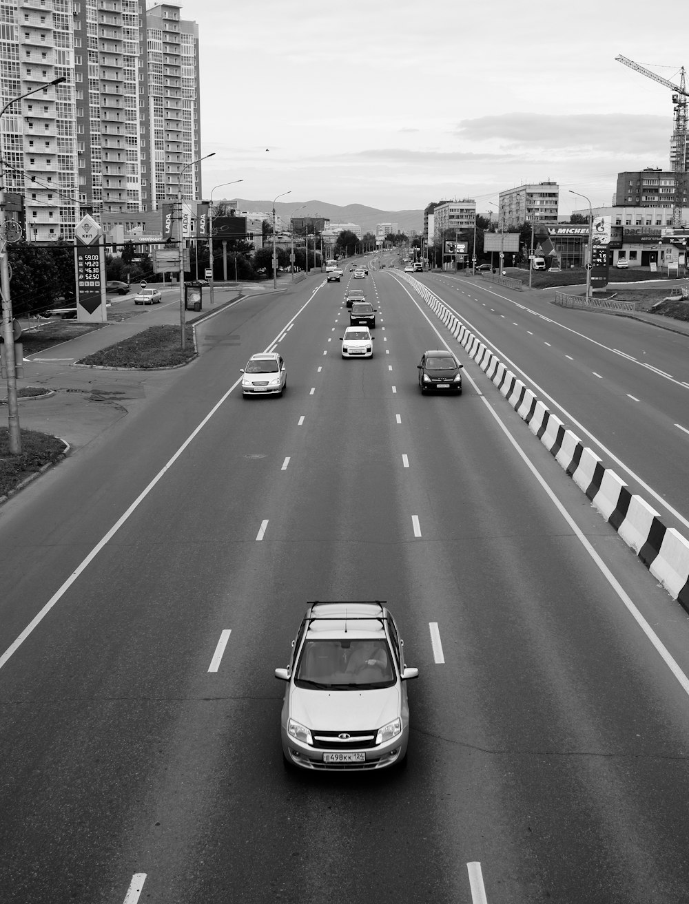 grayscale photo of cars on road