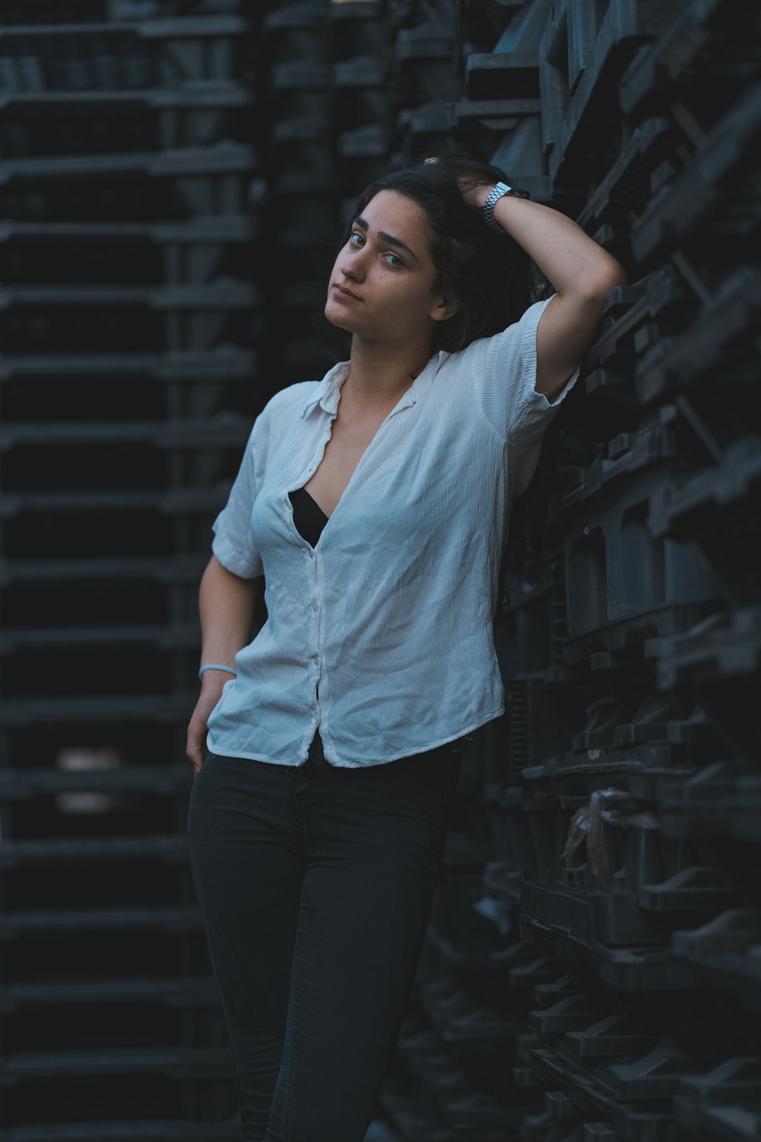 woman in white button up shirt and black pants standing