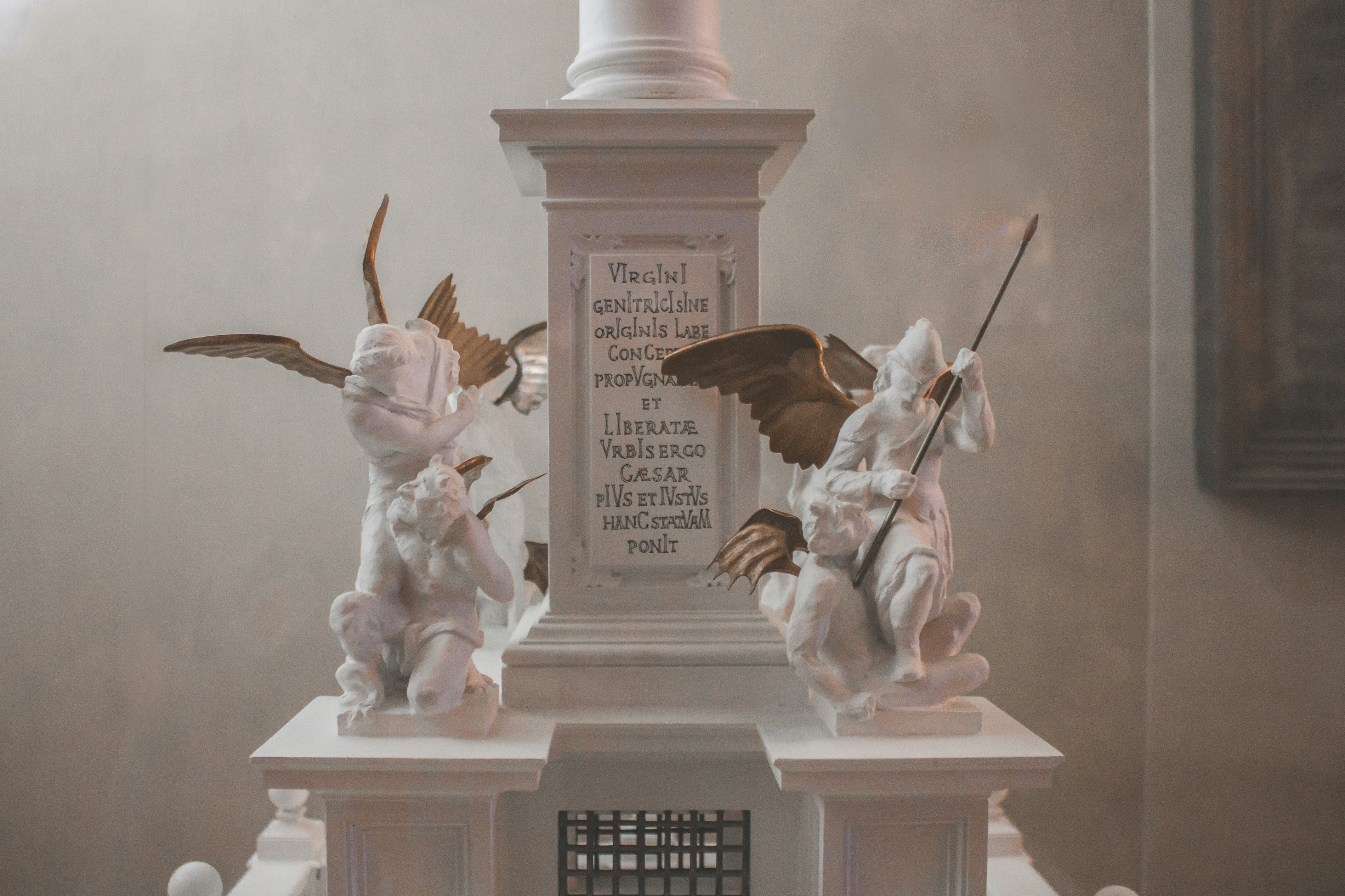 white angel statue on white concrete stand