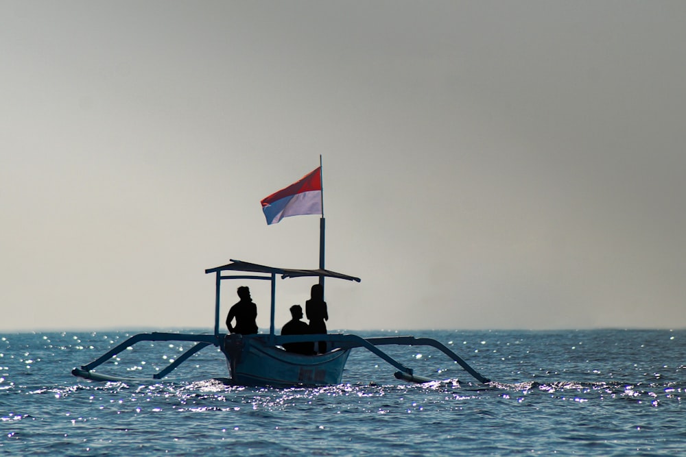 man in black shirt riding on boat with flag of us a during daytime