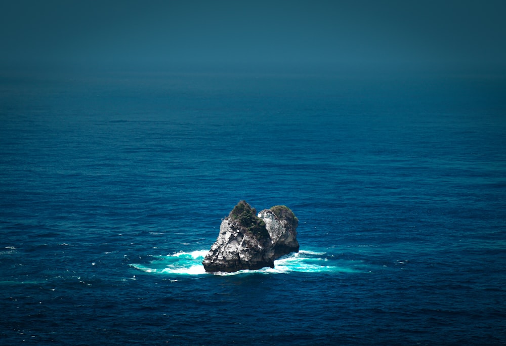 a rock in the middle of the ocean