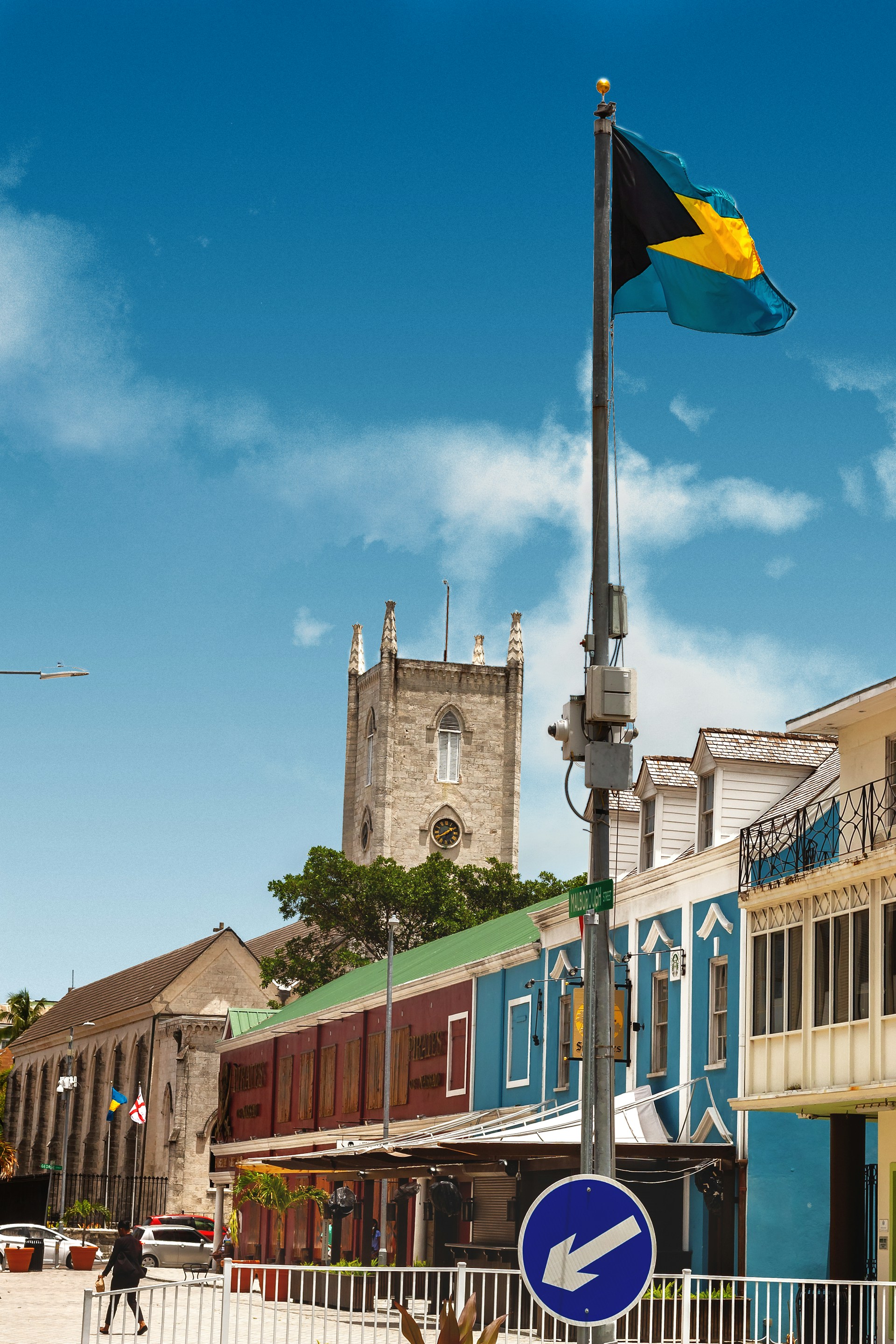 woman wearing yellow long-sleeved dress under white clouds and blue sky during daytime