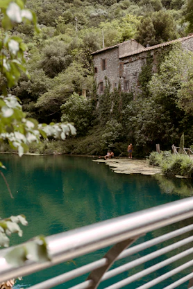 a body of water with a house in the background