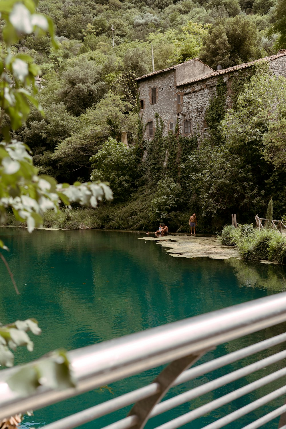 a body of water with a house in the background