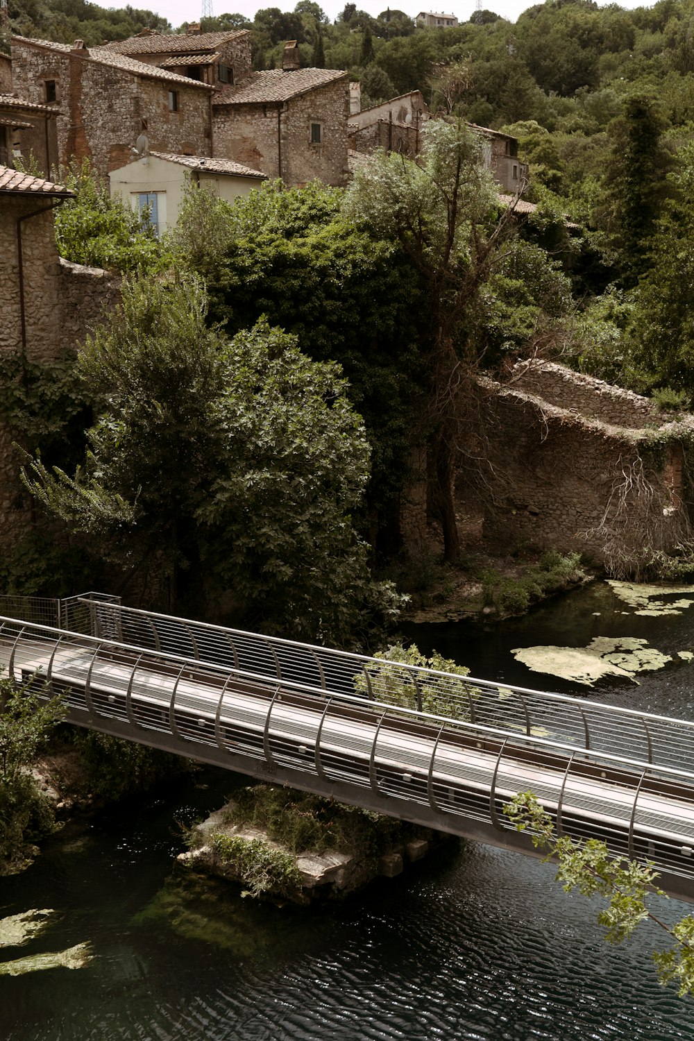 a bridge over a river with a building in the background