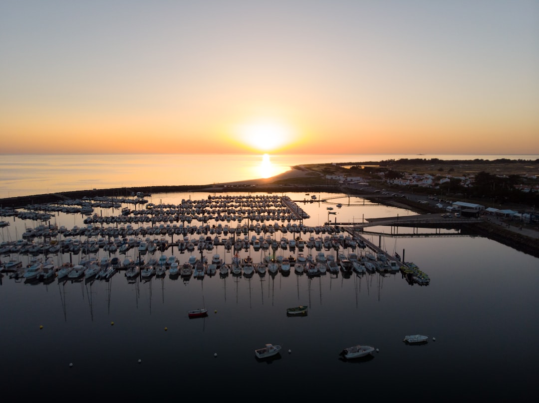 white and black boats on sea during sunset