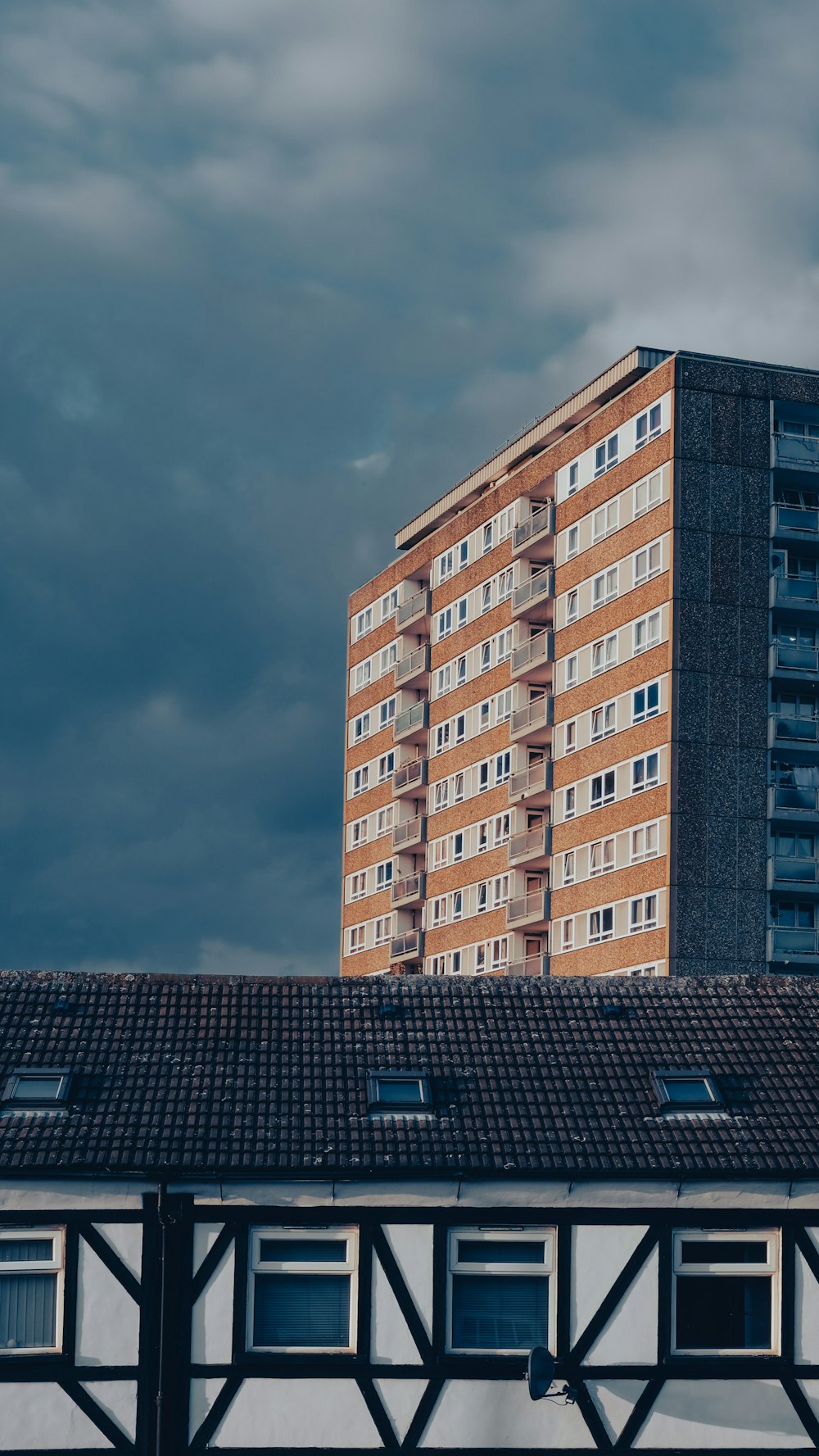 brown and white concrete building under gray sky