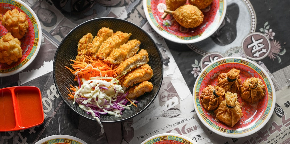 cooked food on black ceramic plates