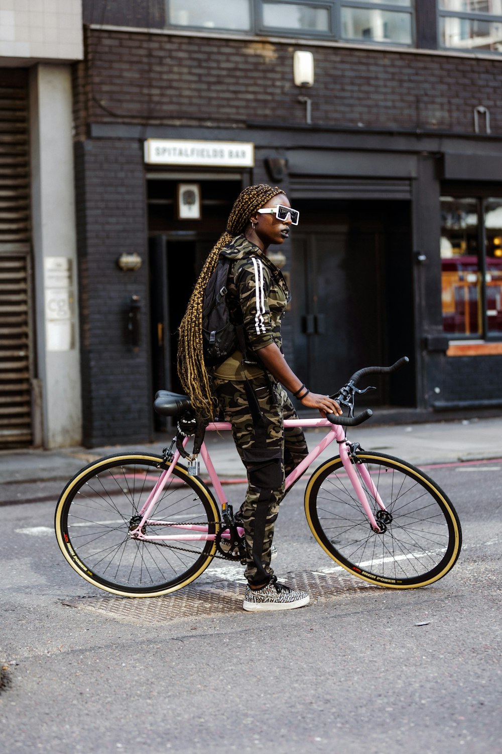 femme en veste à imprimé léopard marron et noir et pantalon noir faisant du vélo  rose photo – Photo Londres Gratuite sur Unsplash