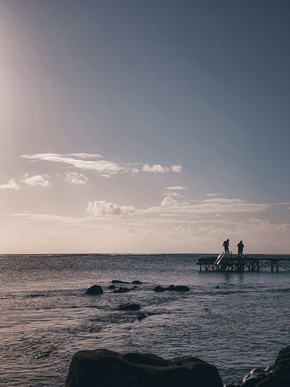 silhouette of people walking on beach during daytime