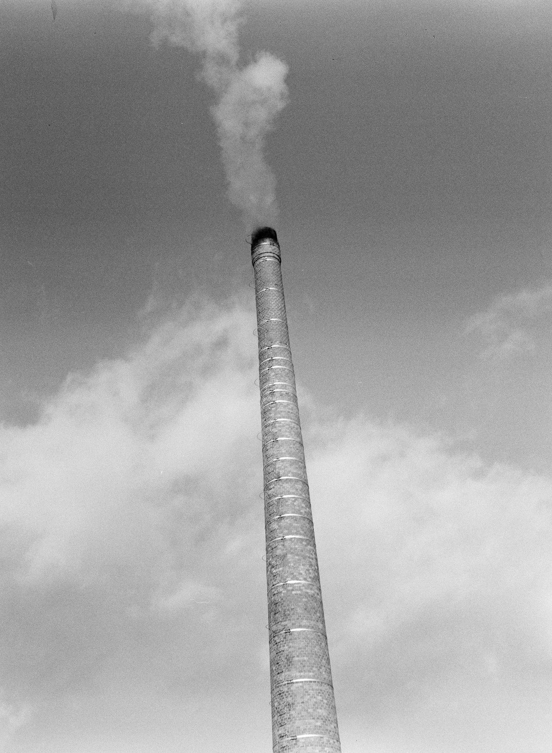 grayscale photo of smoke coming from the sky